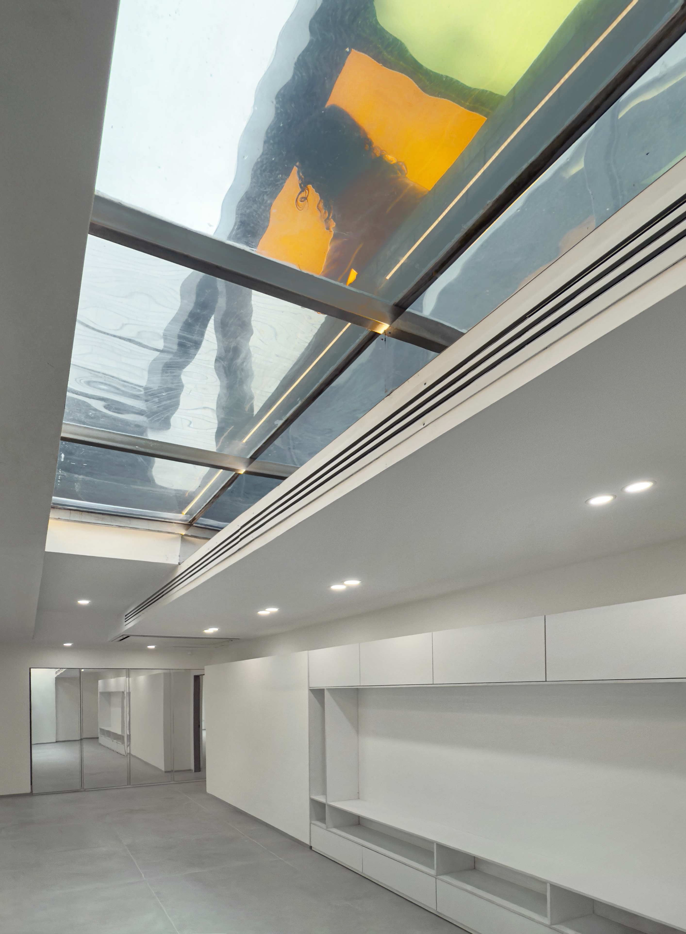 A shallow glass-bottomed pool that lets light into the tv room below, Penthouse, Penthouse at the Jameh-Chin (Pleated Veil) Apartment