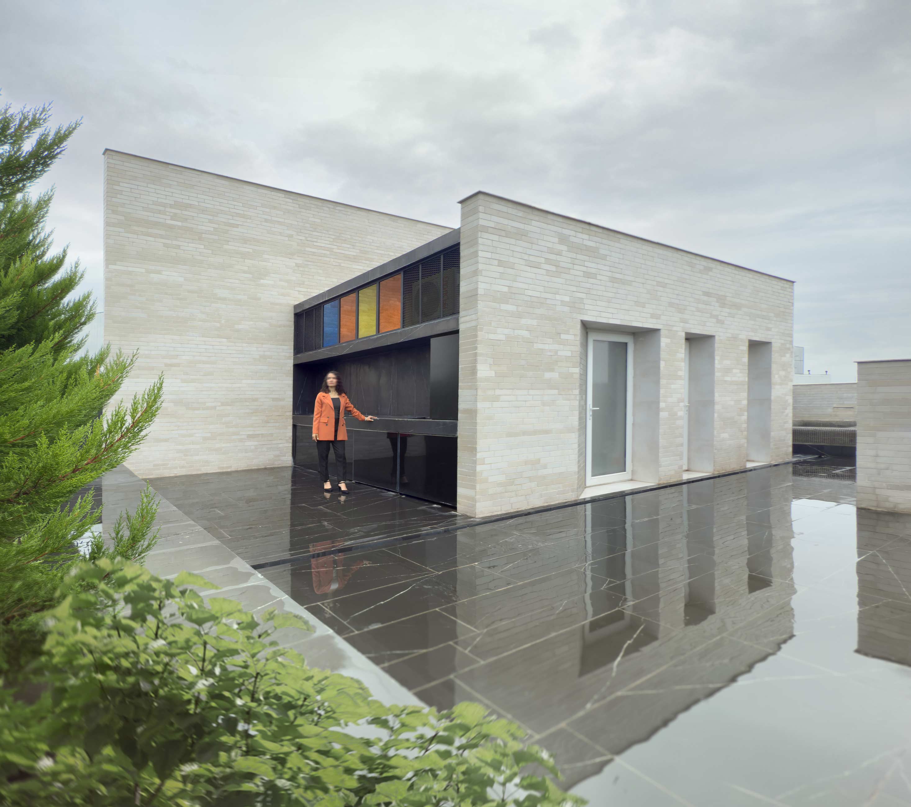 the roof garden, a person in front of the barbeque, the Jameh-Chin (Pleated Veil) Apartment,100 St, Rasht, Iran