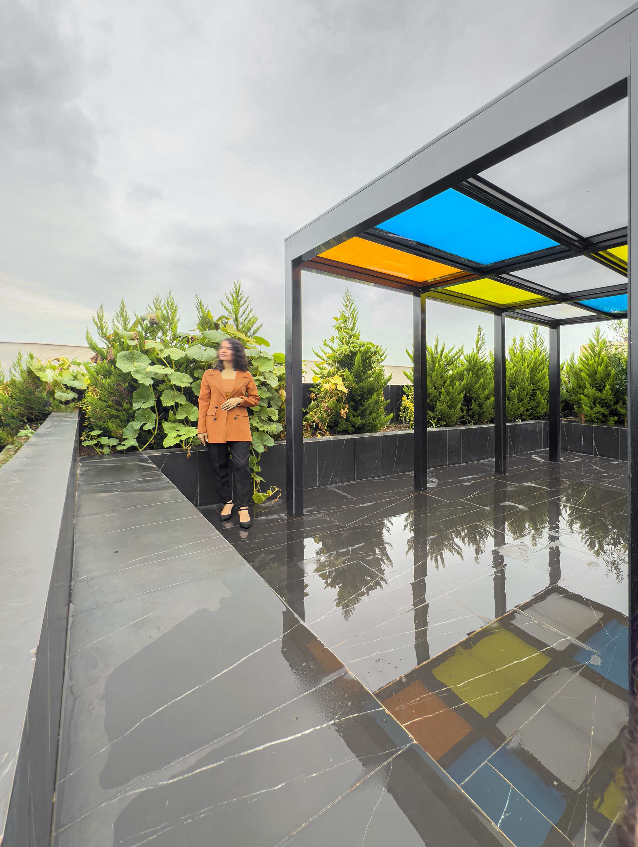 a person in the roof garden, next to the gazebo, the Jameh-Chin (Pleated Veil) Apartment,100 St, Rasht, Iran