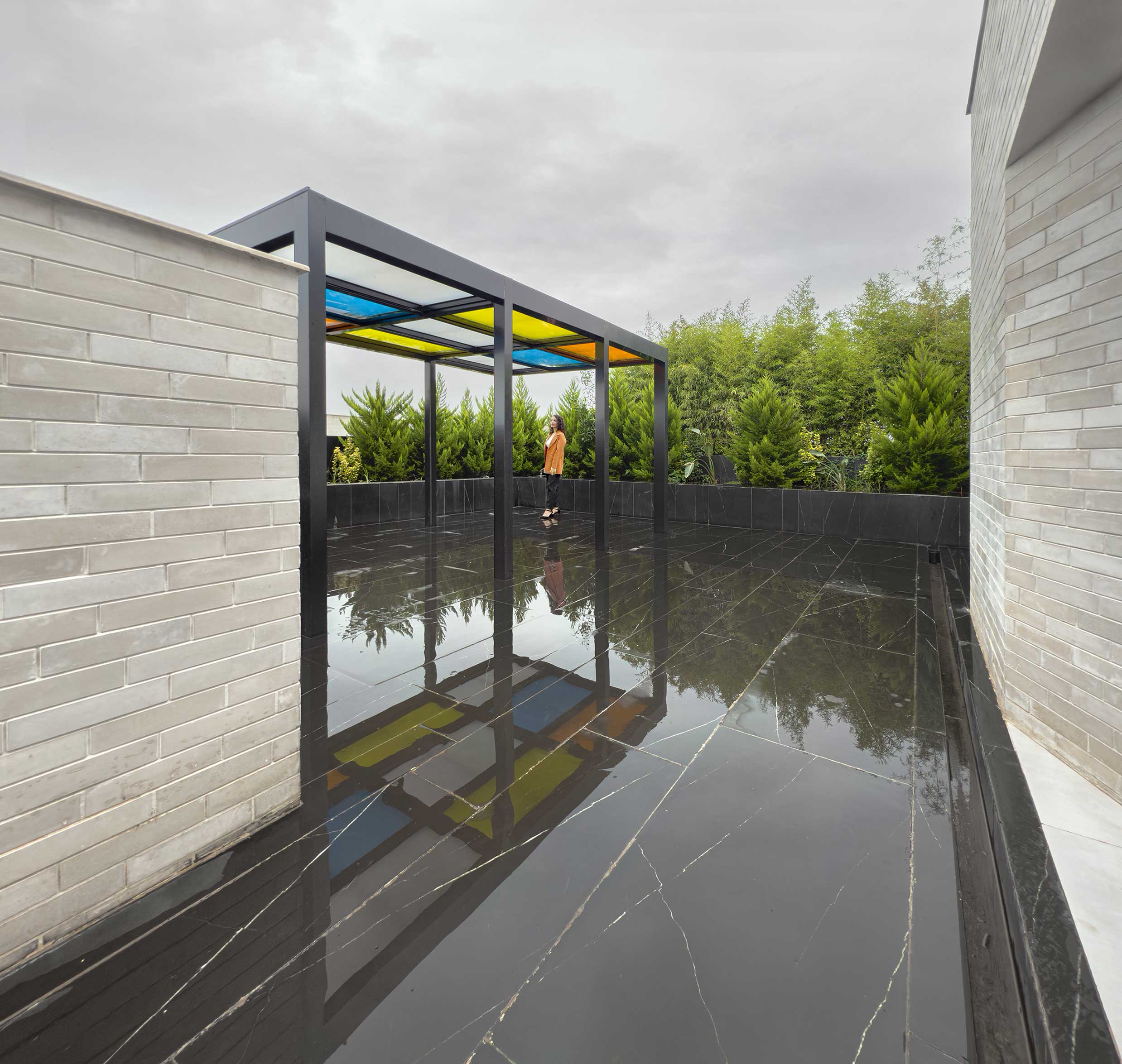 a person in the gazebo, the roof garden, the Jameh-Chin (Pleated Veil) Apartment,100 St, Rasht, Iran